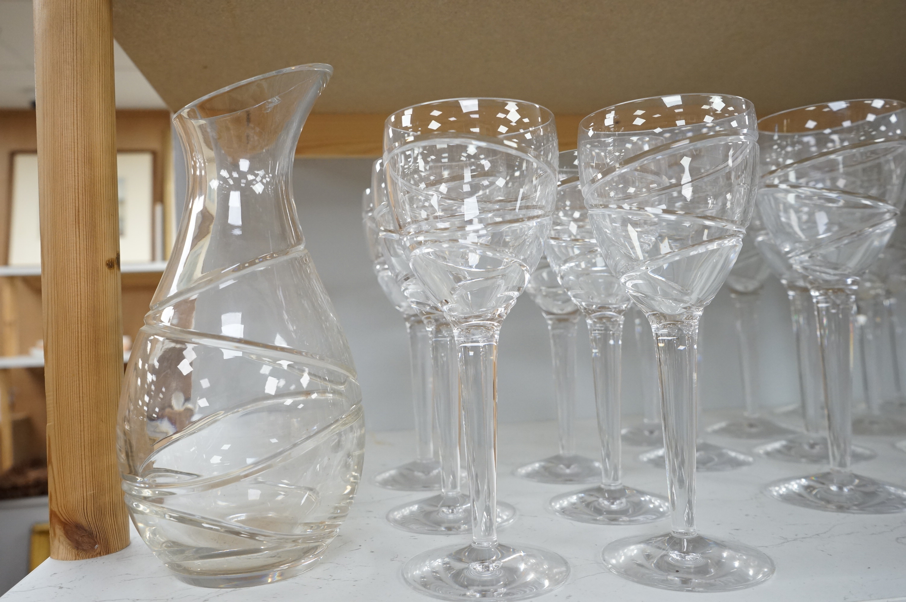 Various part suites of Jasper Conran hand cut Stuart Crystal ‘Aura’ glasses. Including eight Champagne, five large wine and six smaller wine glasses and a carafe, largest 27cm high